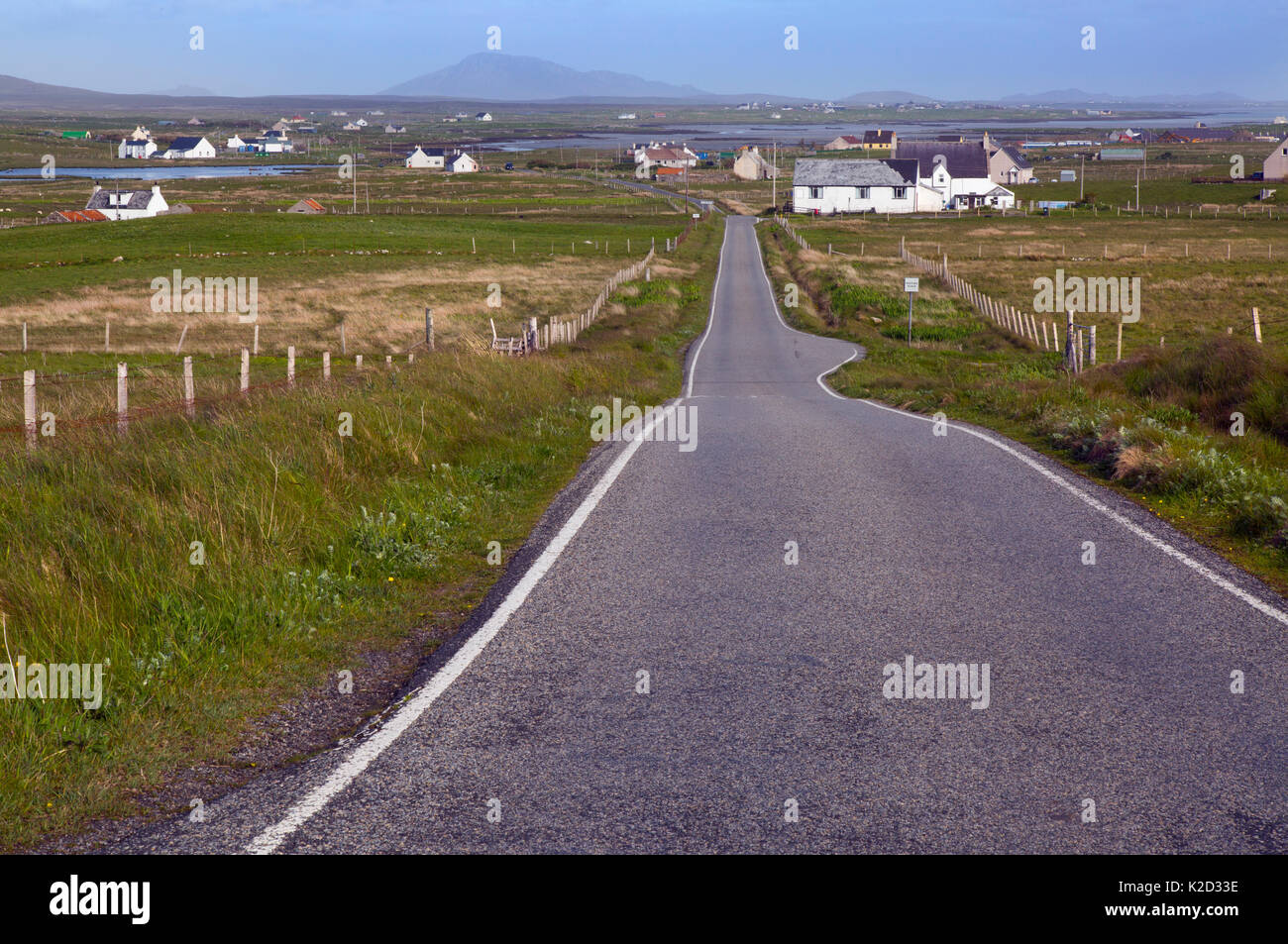 Single track road and crofters houses, Baile Mor, North Uist, Outer Hebrides, Scotland, UK, June. Stock Photo