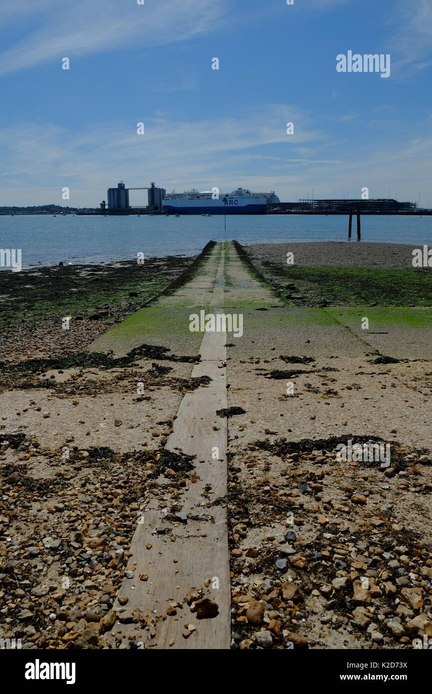 An old concrete boat launch stretches into the Solent at Weston Shore Stock Photo