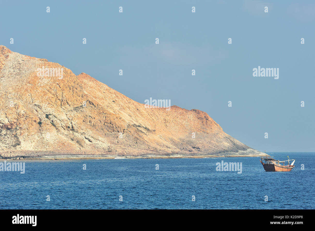 A fishing boat close to Al Qibliyah island, one of the Hallaniyat islands, coast of Dhofar, Oman, Arabian Sea Stock Photo