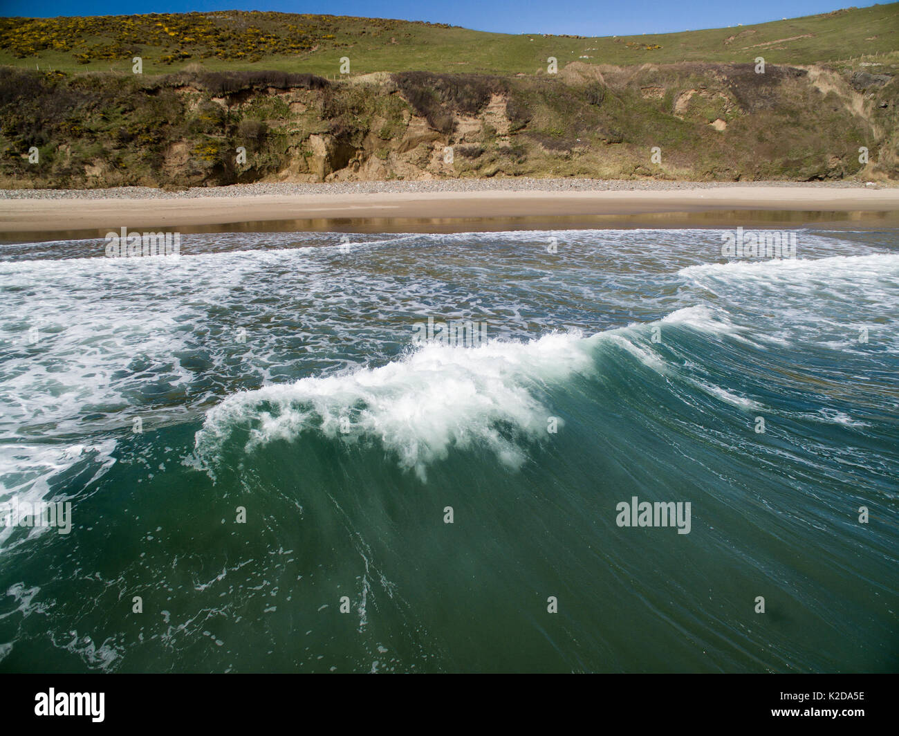 A view from the back of a breaking wave, Porth Ceiriad, Abersoch, Wales UK April Stock Photo