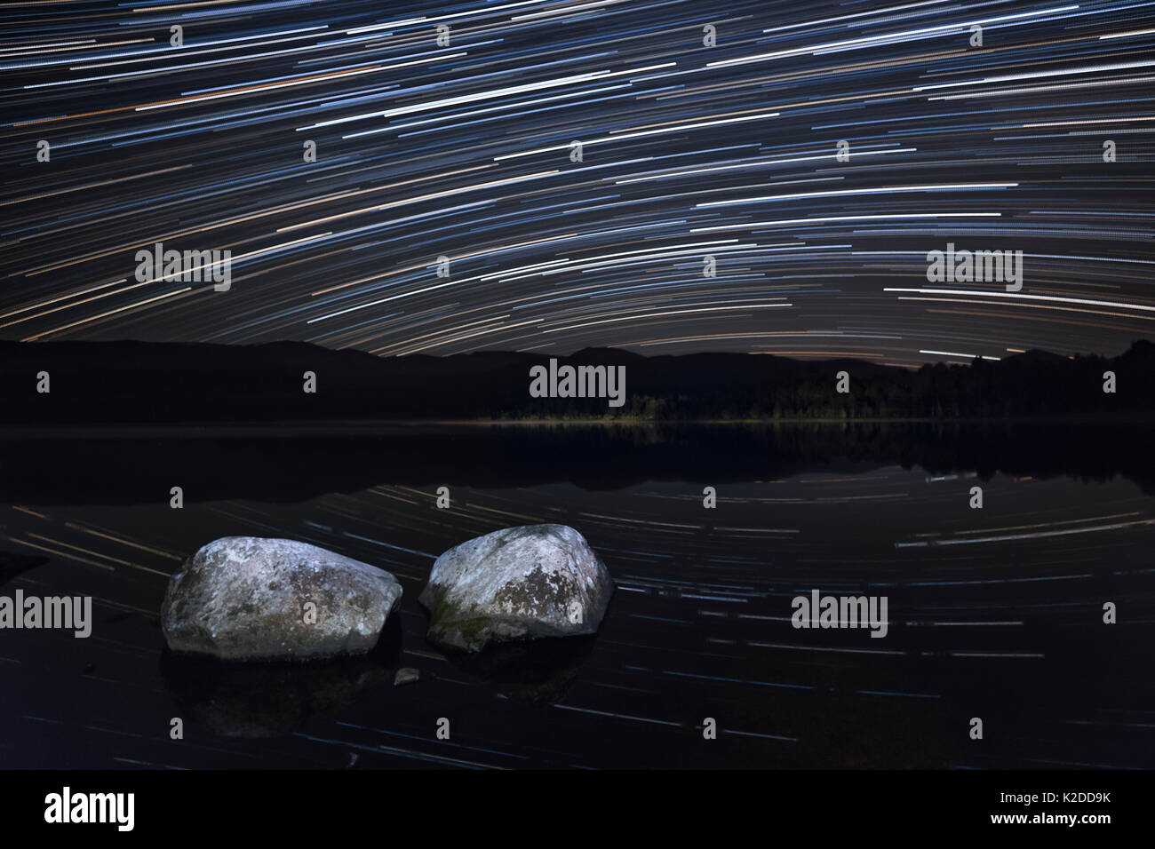 Night sky over Loch Morlich with star trails, Cairngorms National Park, Cairngorms, Scotland, UK, September 2015. Stock Photo