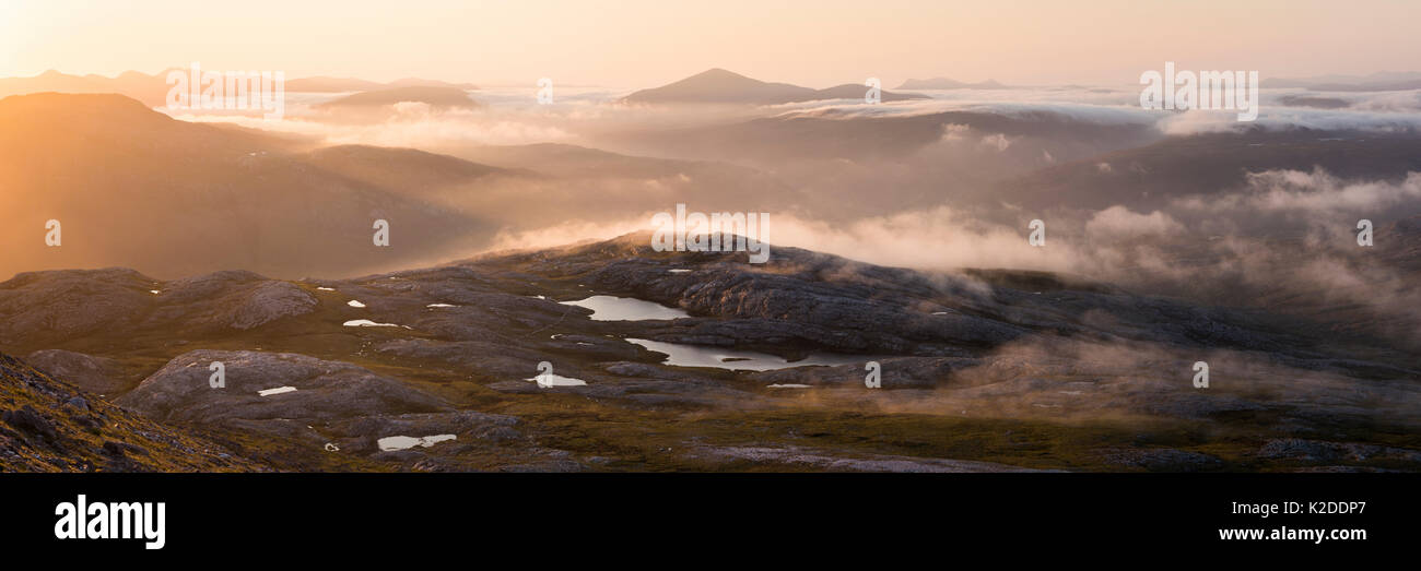 A misty panorama from Meall a Ghiubhais overlooking Lunar Loch at sunrise. Torridon, Scotland, UK, June 2016. Stock Photo