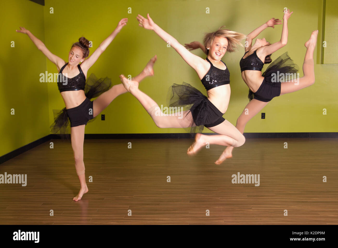 Three young female dancers posing and jumping in the air Stock Photo