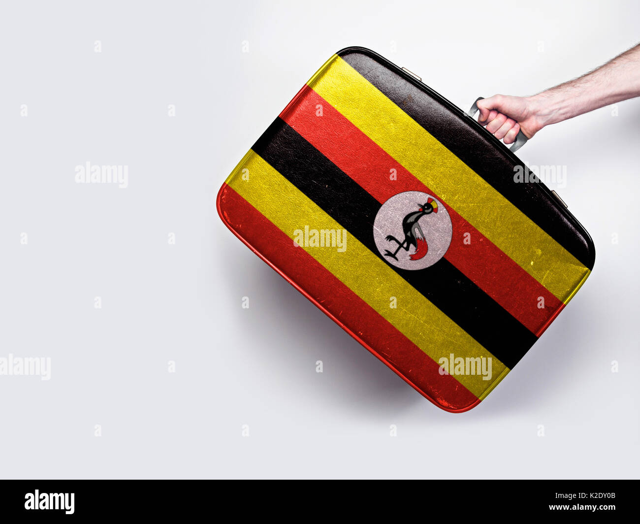 Uganda flag on a vintage leather suitcase. Stock Photo