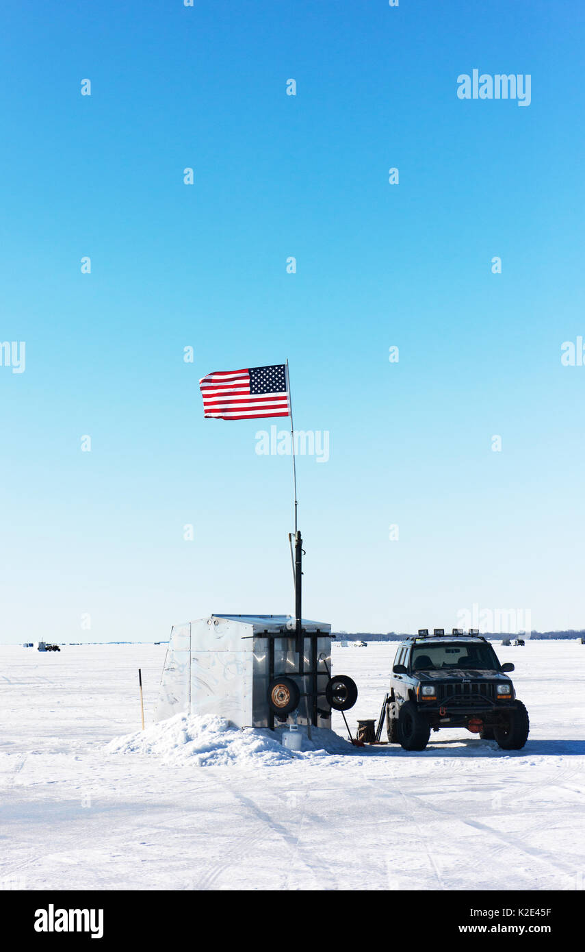 Fishing shed of an ice fisherman on frozen Lake Winnebago, with truck and American flag. Stock Photo