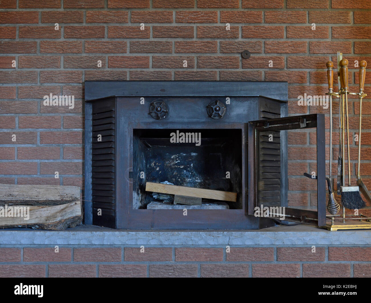 Wood Stove Or Fireplace Insert In Rustic Cabin Stock Photo