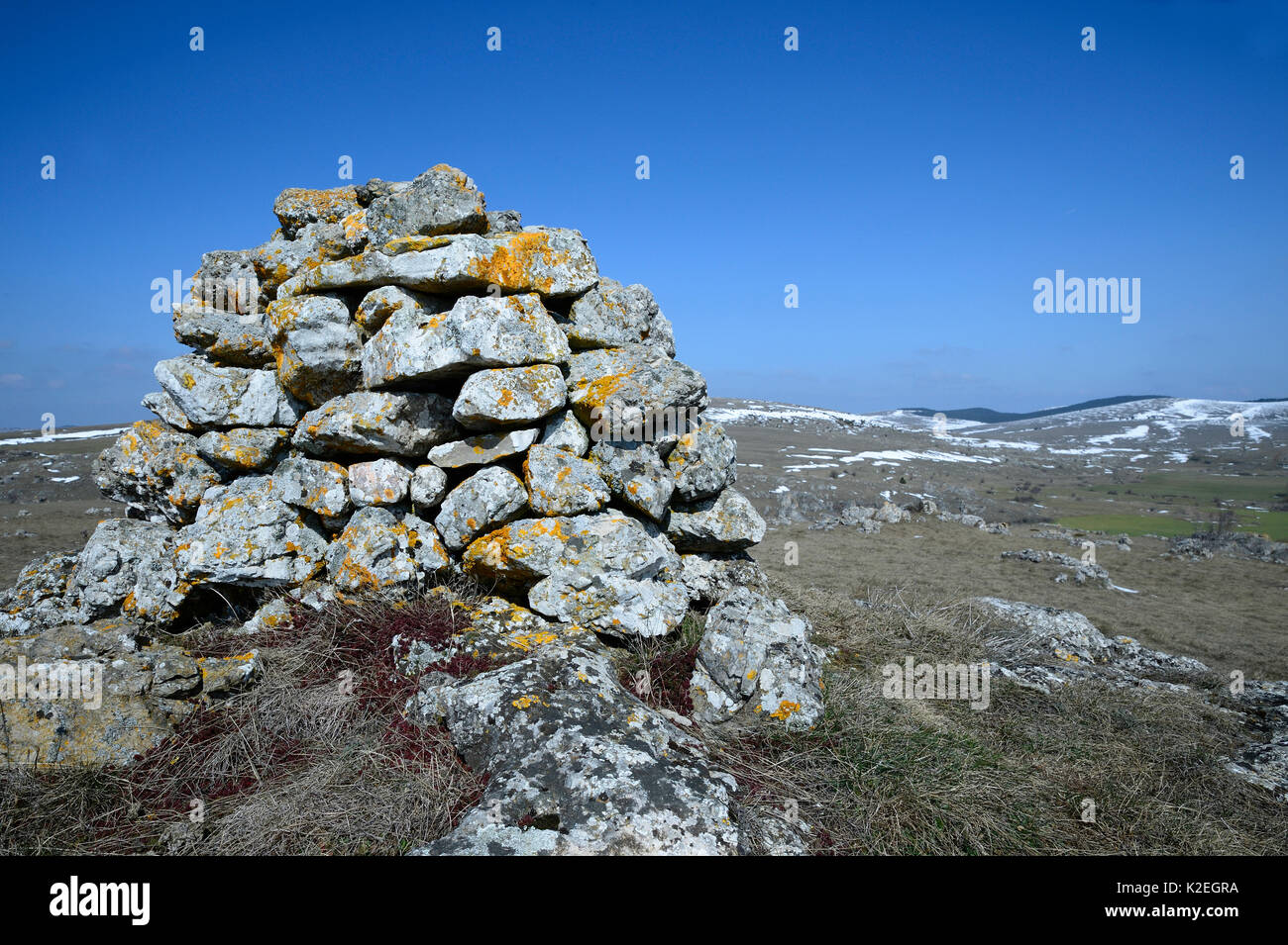 Stone cairn in upland landscape, Causse Mejean,  Cevennes National Park, France, March. Stock Photo