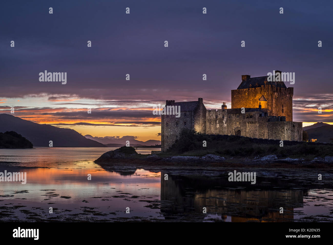Illuminated Eilean Donan Castle at sunset in Loch Duich, Ross and Cromarty, Western Highlands of Scotland, UK, September, 2016 Stock Photo