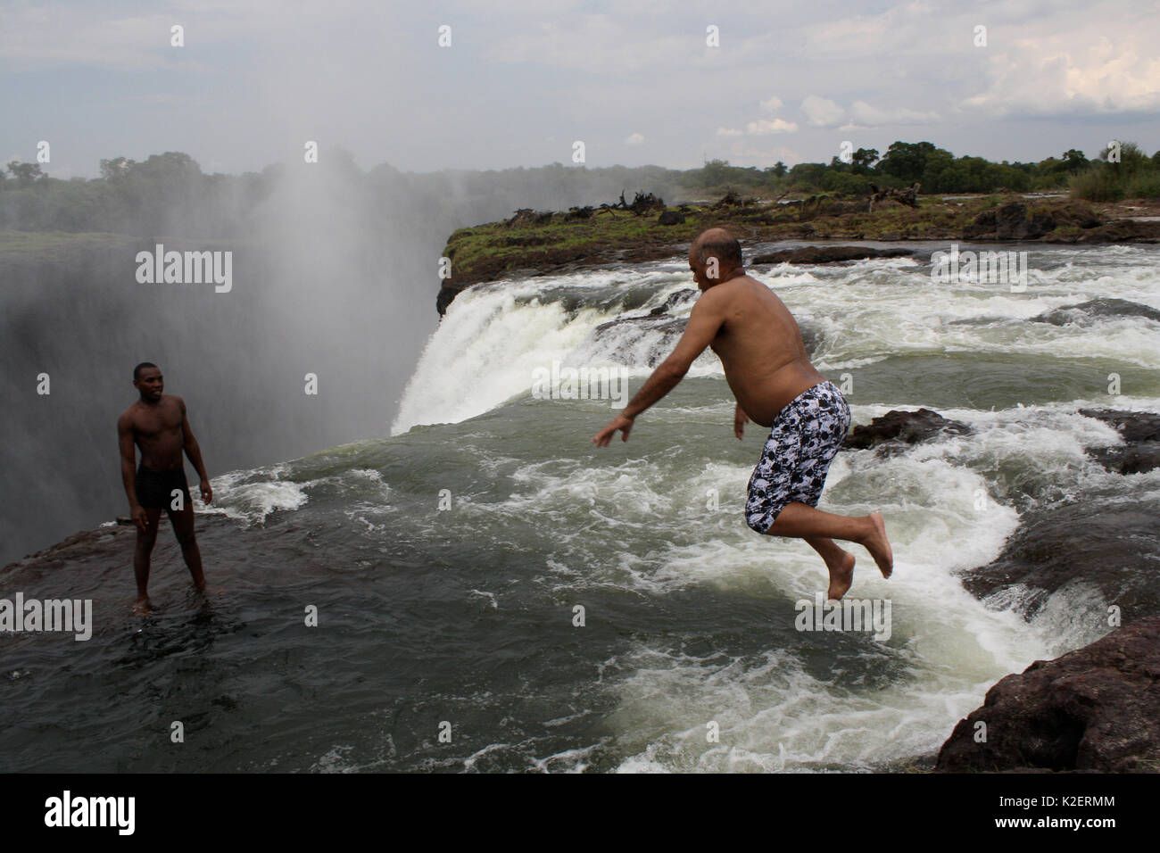 Photographer Steve O Taylor jumping into the Victoria Falls, Zambia November 2010. Stock Photo