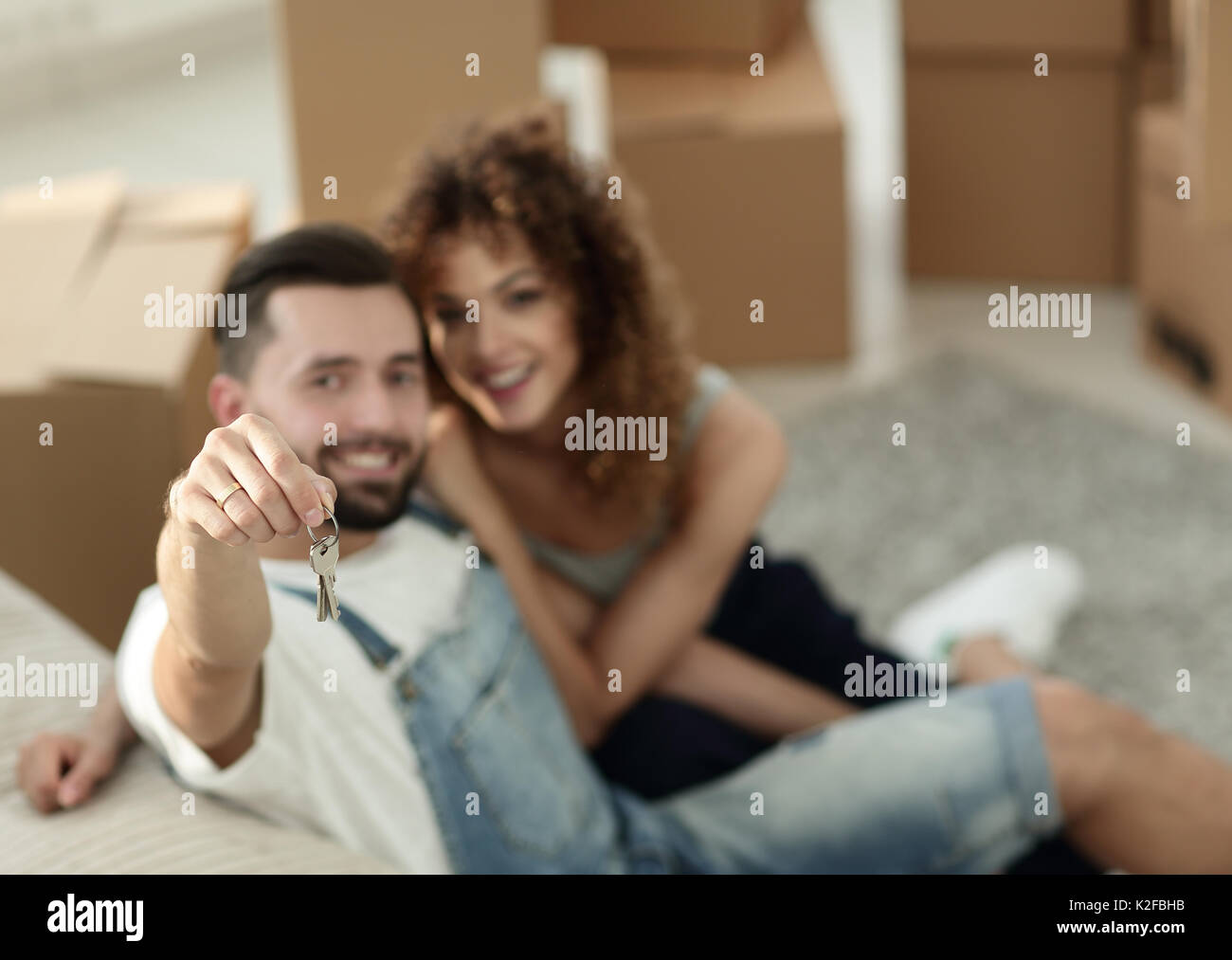 young couple holding the key to a new apartment Stock Photo - Alamy