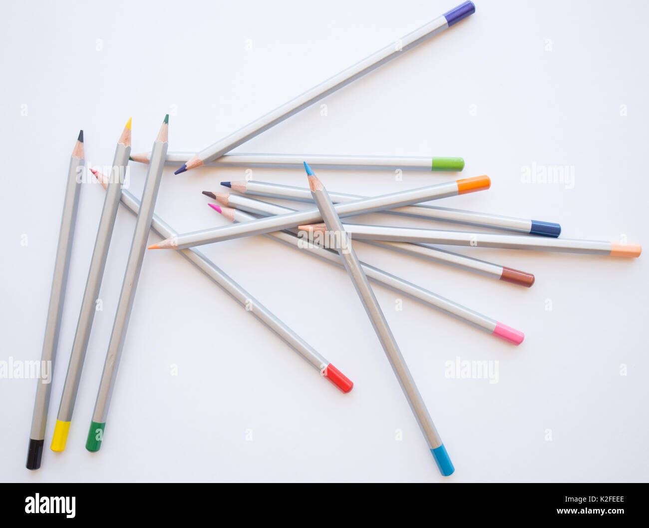 Coloured Pencils Lying in disarray on a white background, learn to draw, step by step Stock Photo