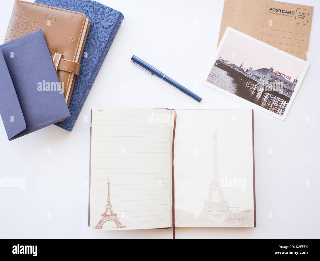 Concept from different type of notebooks, blue envelope and post cards on a white background. Stock Photo