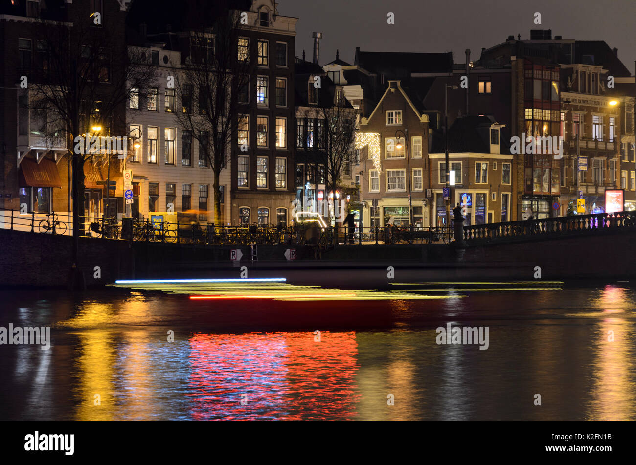 Light tracks of canal boats, Amsterdam, Netherlands Stock Photo
