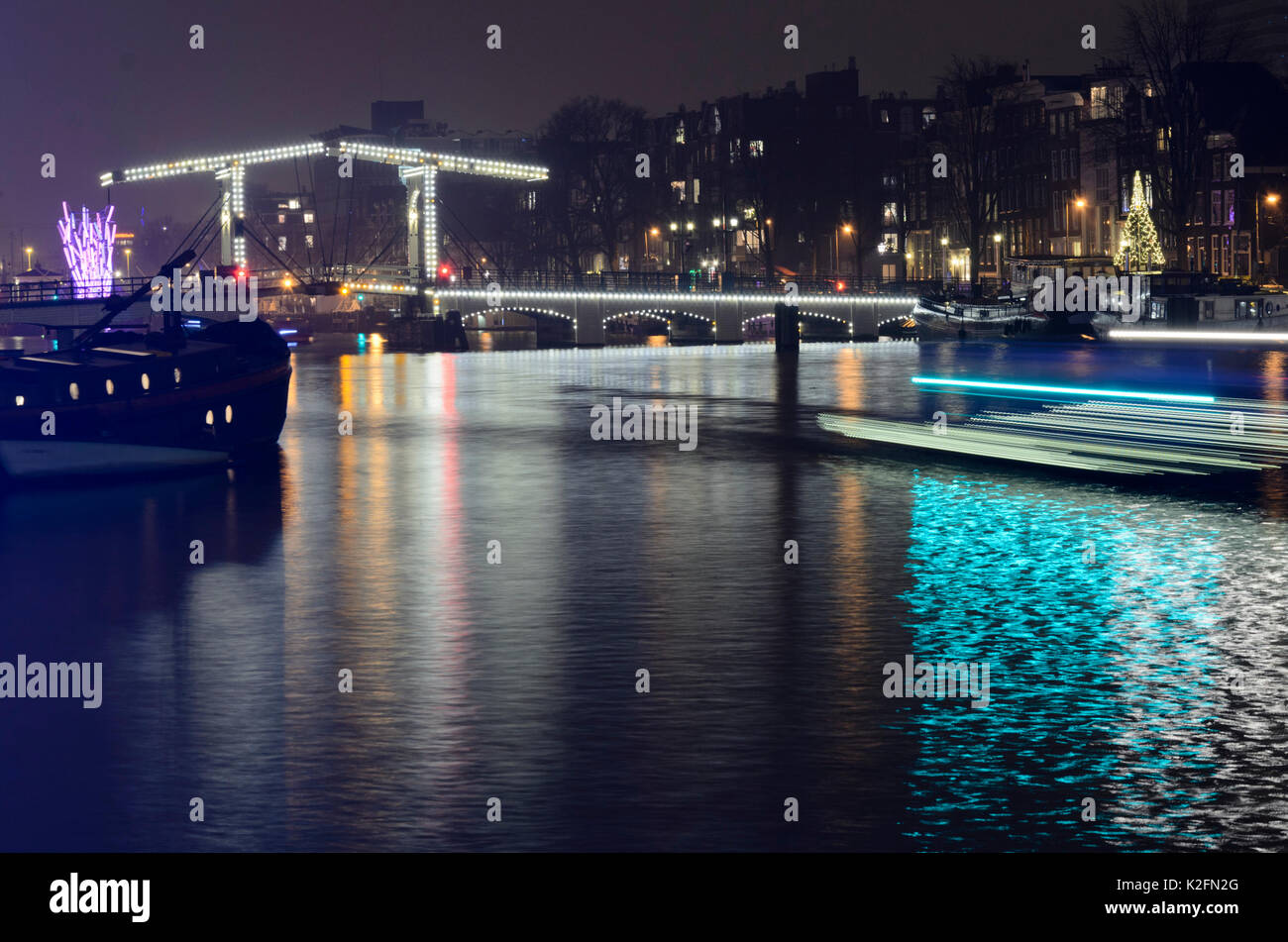 Light tracks of canal boats, Amsterdam, Netherlands Stock Photo
