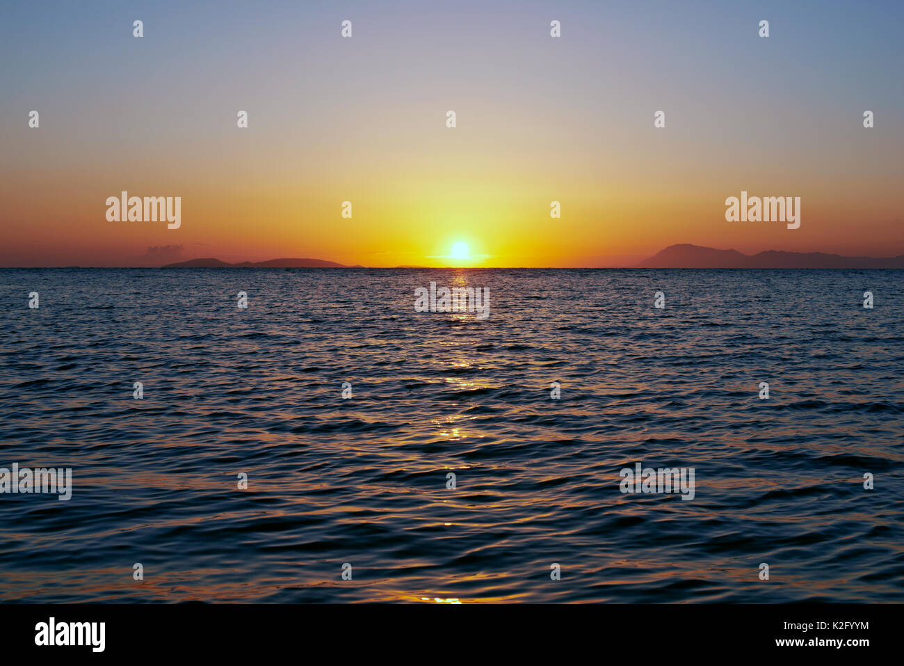 Sunset over water Stock Photo - Alamy