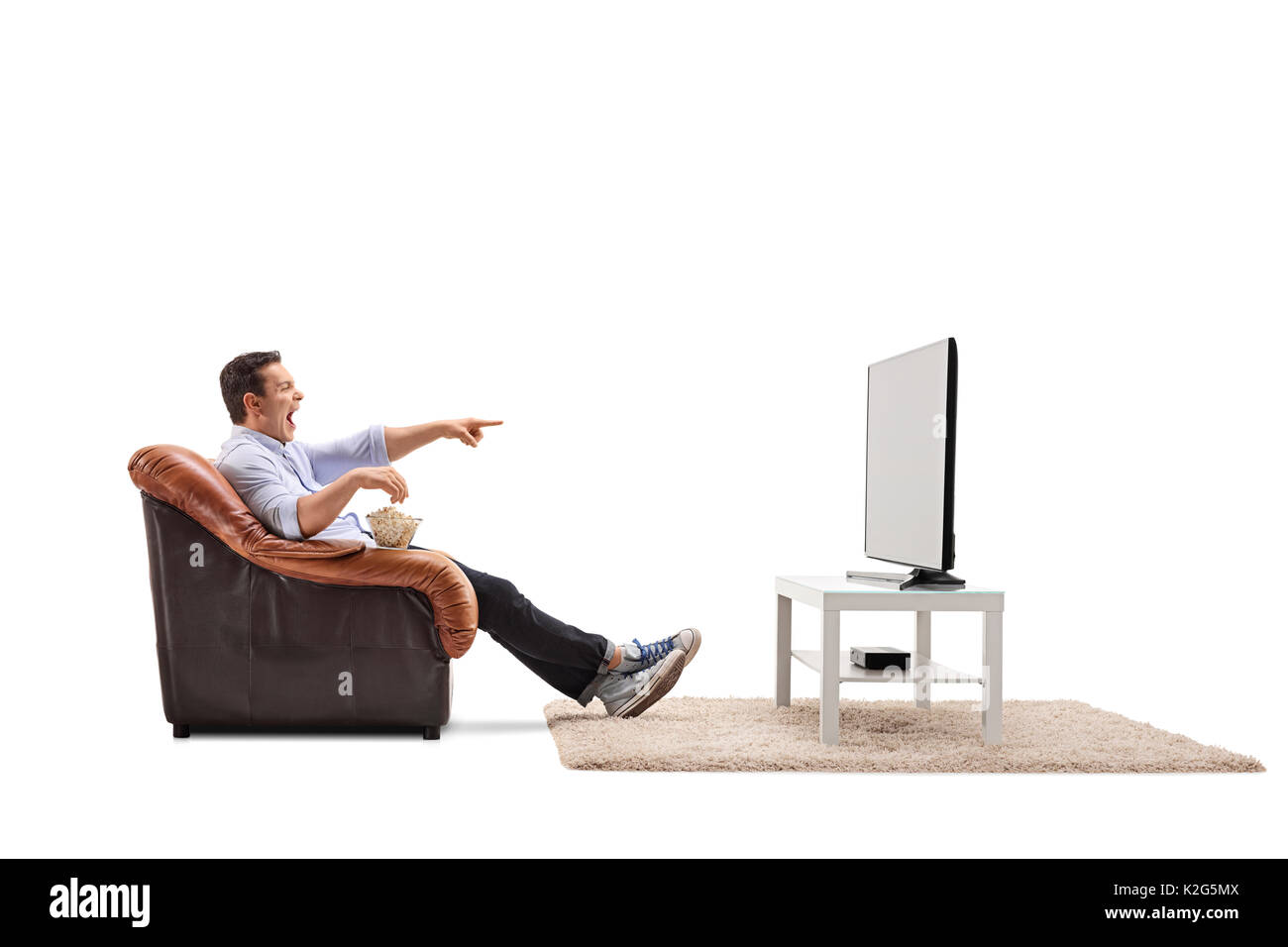 Man armchair watching tv hires stock photography and images Alamy