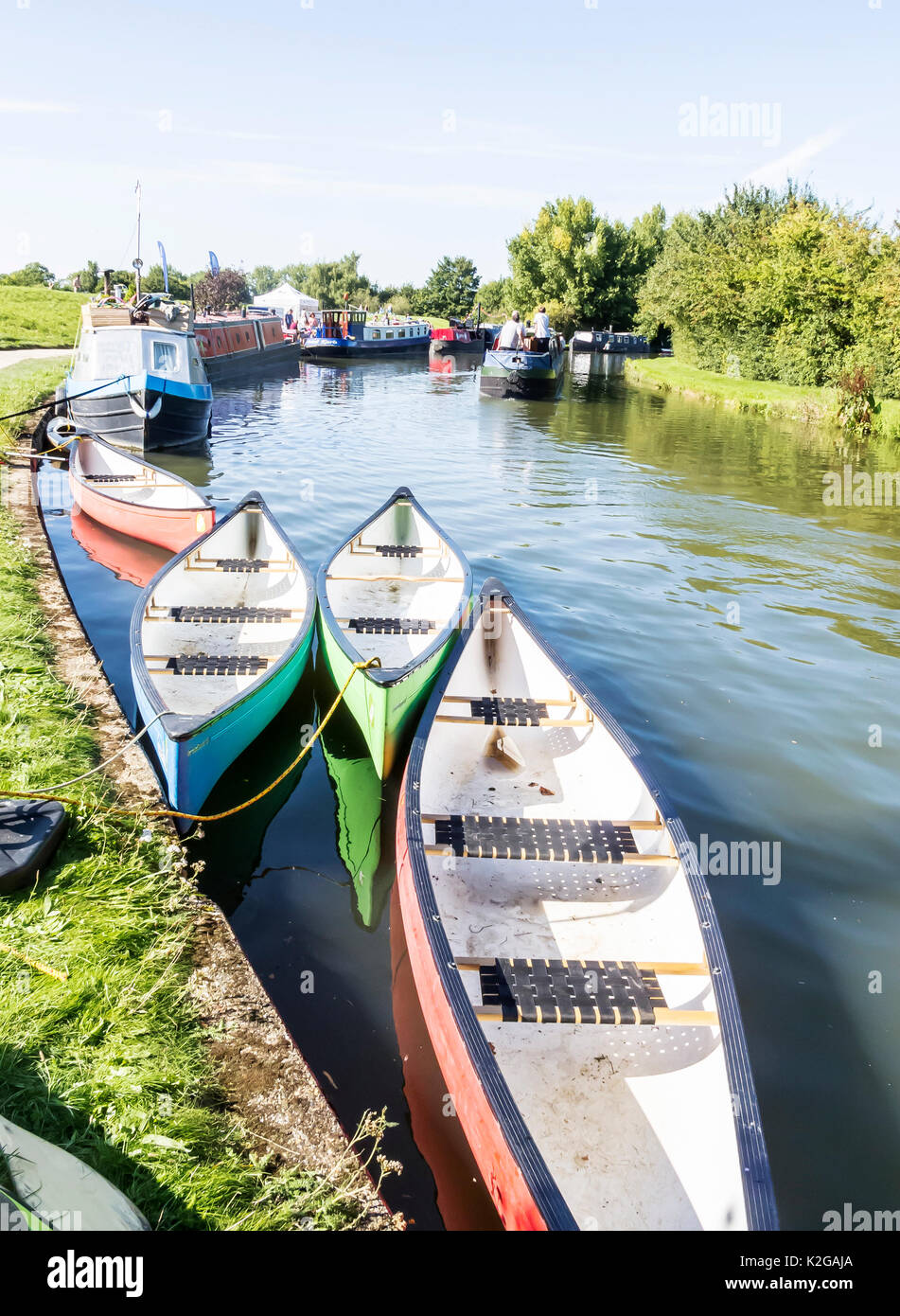 Colourful canoes moored  on the Grand Union Canal at Marsworth, in the Vale of Aylesbury, Bucks Stock Photo