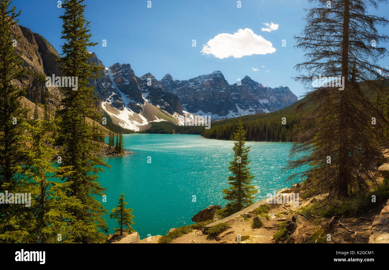 Beautiful sunny day at Moraine lake in Banff National Park, Alberta, Canada, with snow-covered peaks of canadian Rocky Mountains in the background. Stock Photo