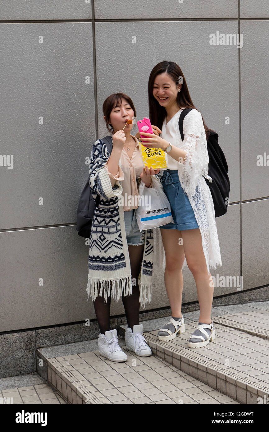 Tokyo, Japan -  May 12, 2017: Japanese girls making fun and a self portrait in the street of Tokyo Stock Photo