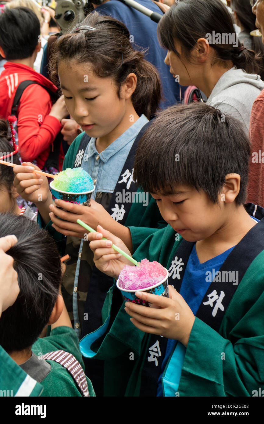 Tokyo, Japan - May 14, 2017: Children in the crowd eating colorful ice cream at the Kanda Matsuri Festval Stock Photo
