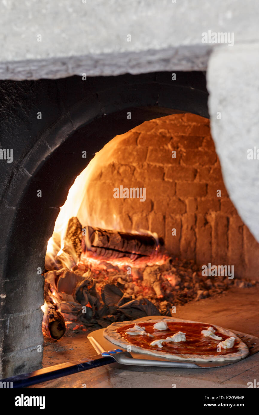 Thermometer with glowing embers in an outdoor wood-burning pizza oven for  cooking and baking Stock Photo - Alamy