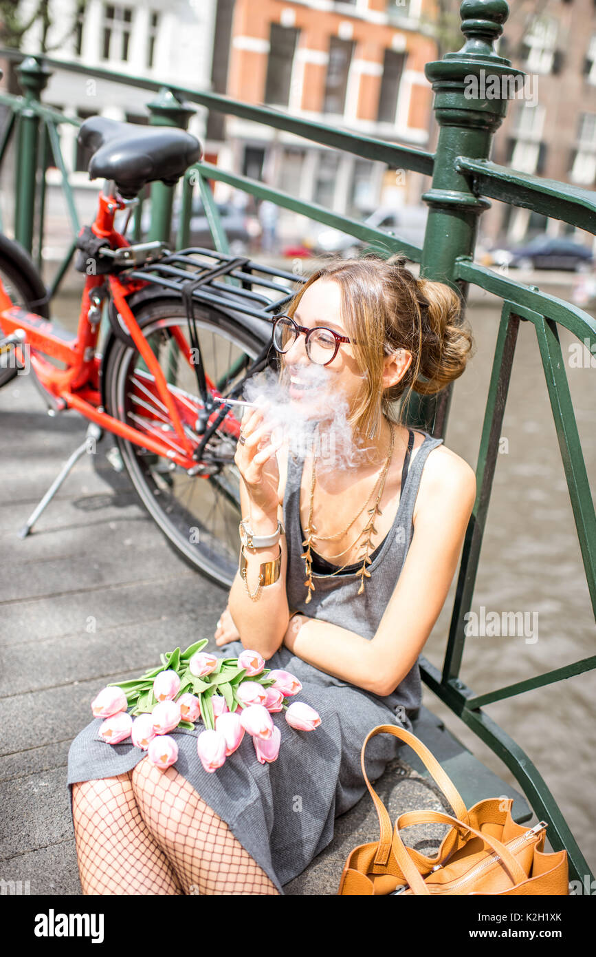 Woman smoking in Amsterdam city Stock Photo Alamy