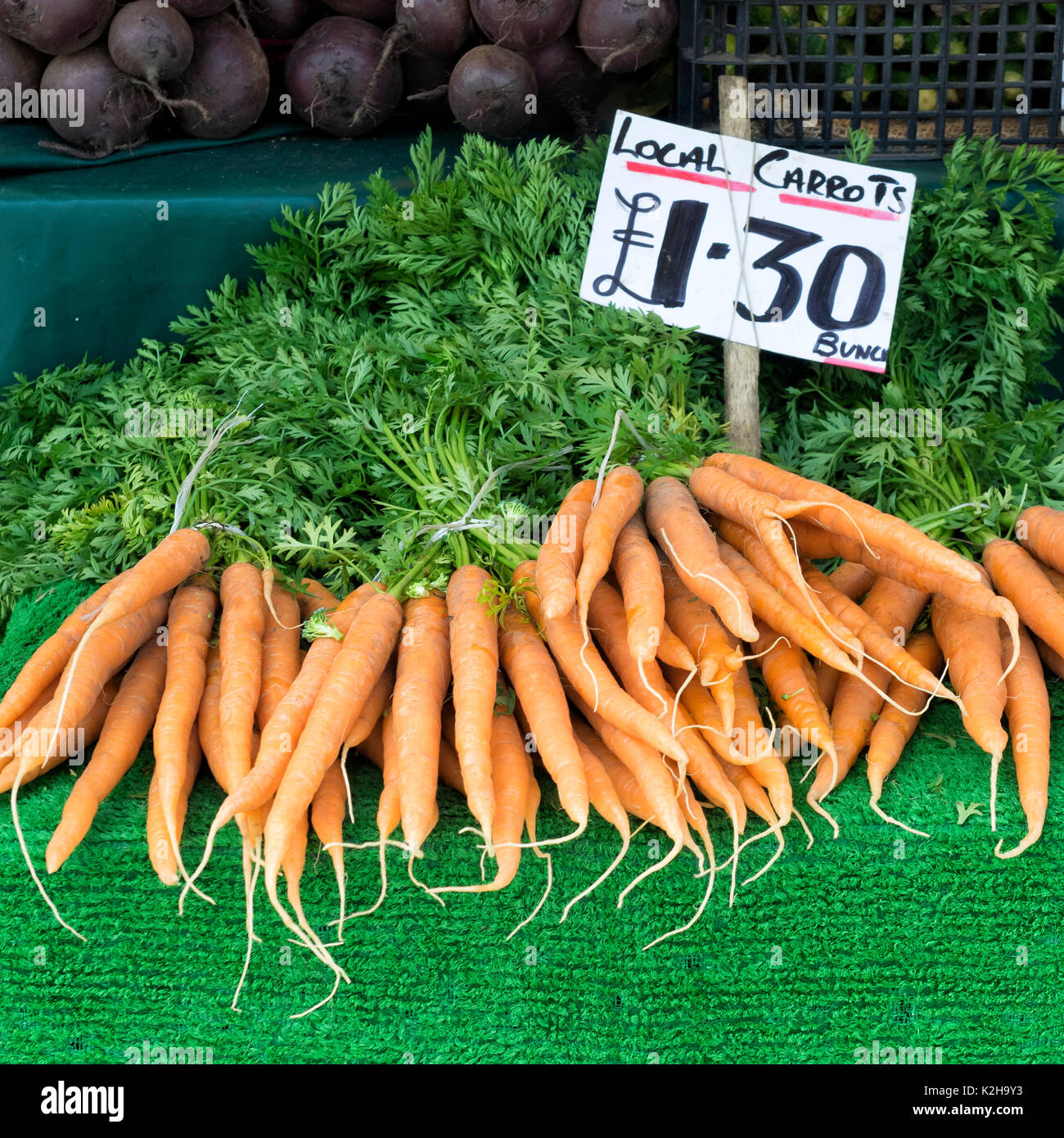 CAMBRIDGE, UK - AUGUST 11, 2017:  Local Grown Carrots for sale on a market stall Stock Photo