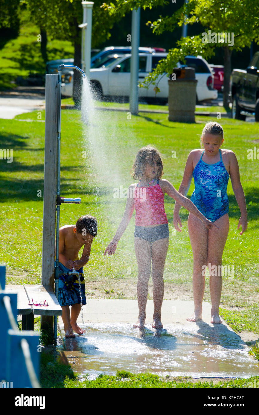 Two female children playing in the shower area at a public beach on a Stock Photo - Alamy Two female children playing in the shower area at a public beach on a Stock Photo - Alamy