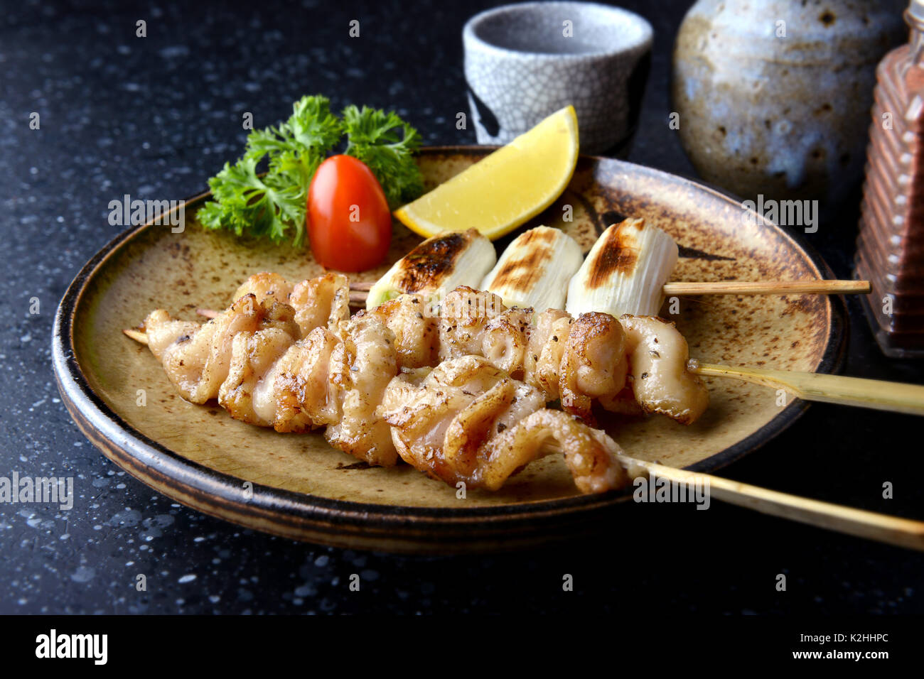 Chicken skin grilled with charcoal fire in Japanese style call torikawa or yakitori serve in izakaya food restaurant. Stock Photo