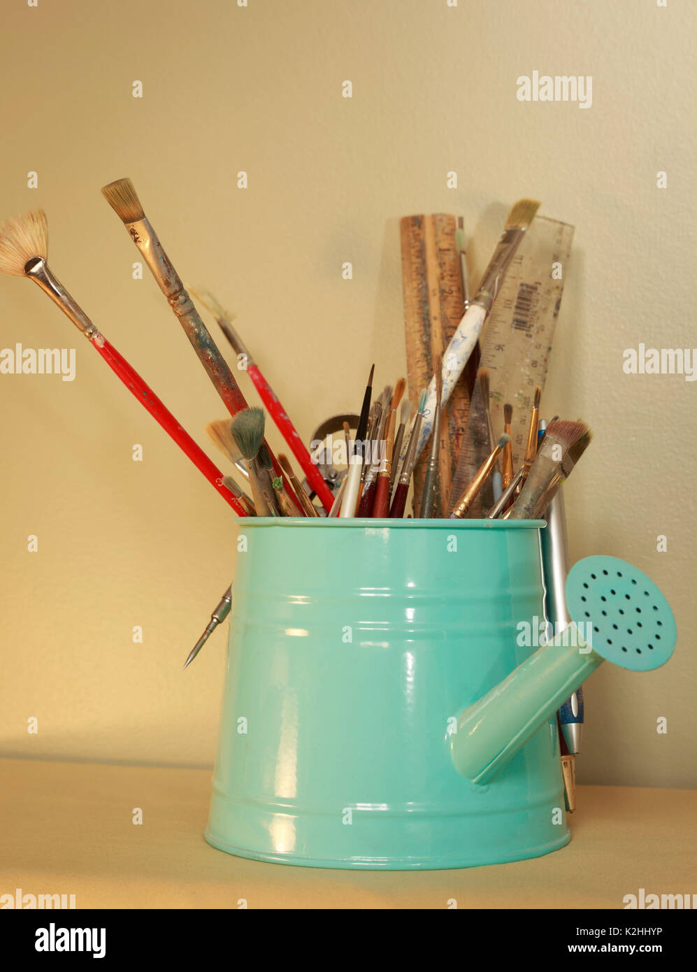 Turquoise container holding art supplies Stock Photo