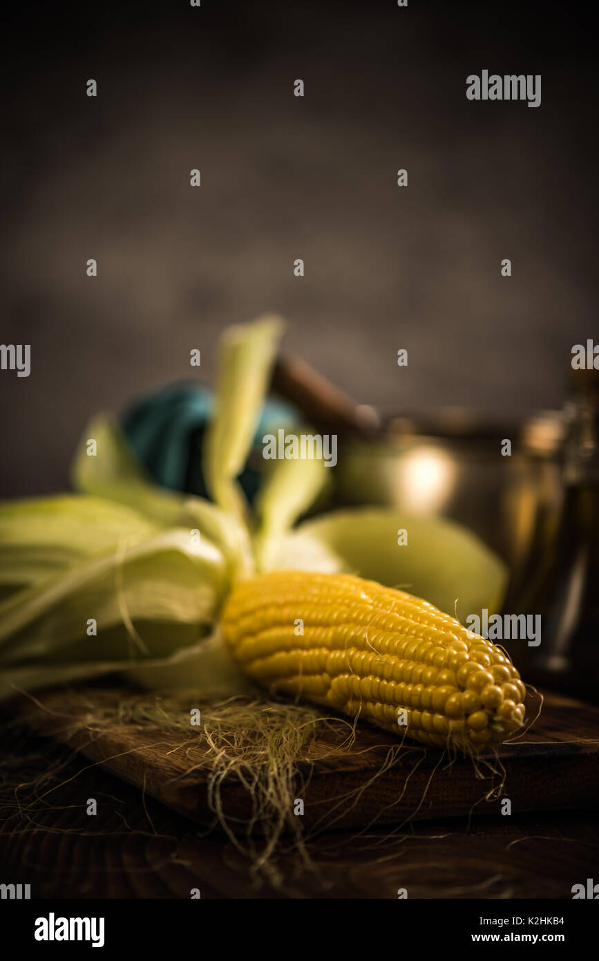 Whole corn on hob with husk, ready for cooking Stock Photo Alamy