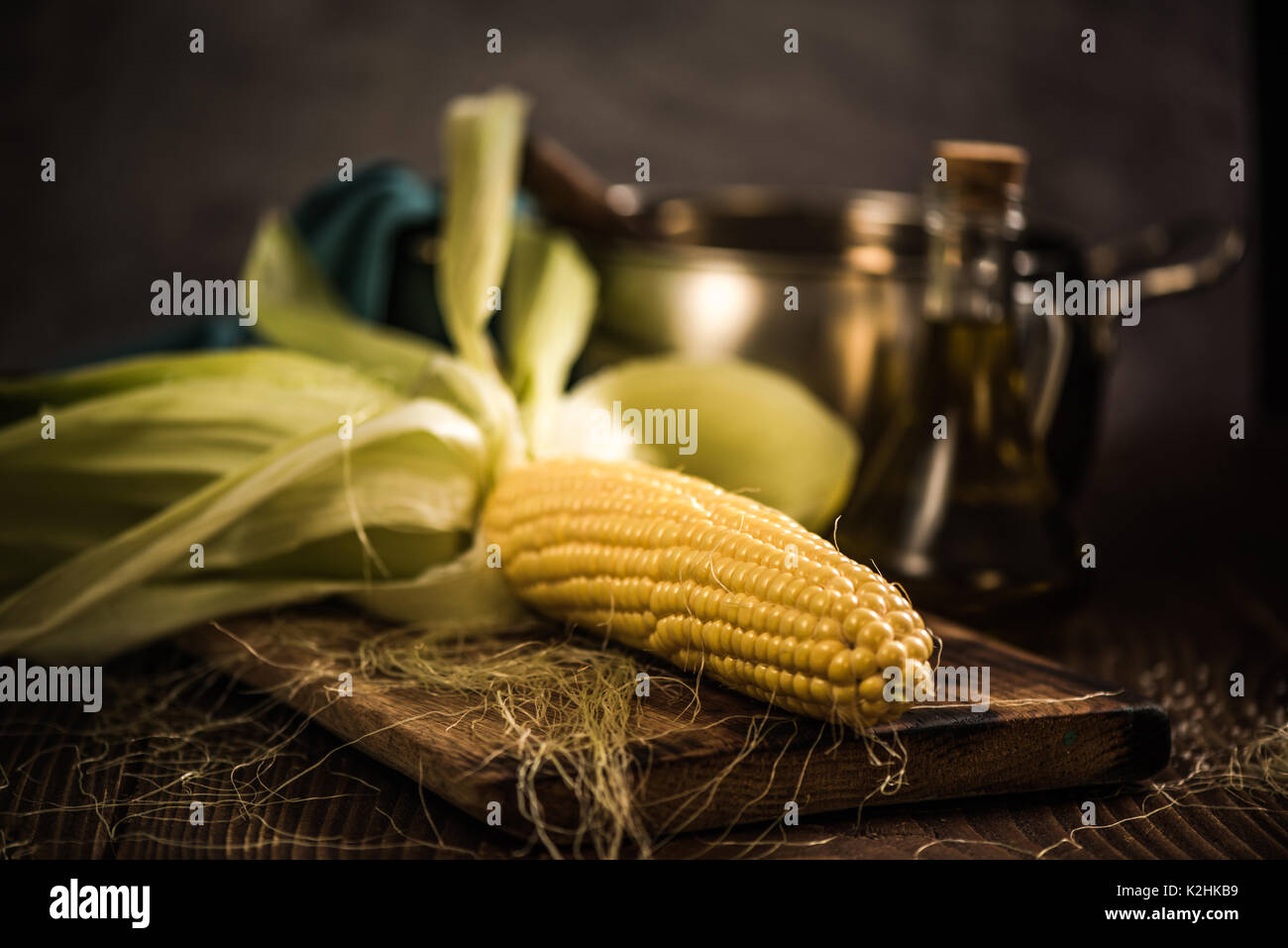 Whole corn on hob with husk, ready for cooking Stock Photo Alamy