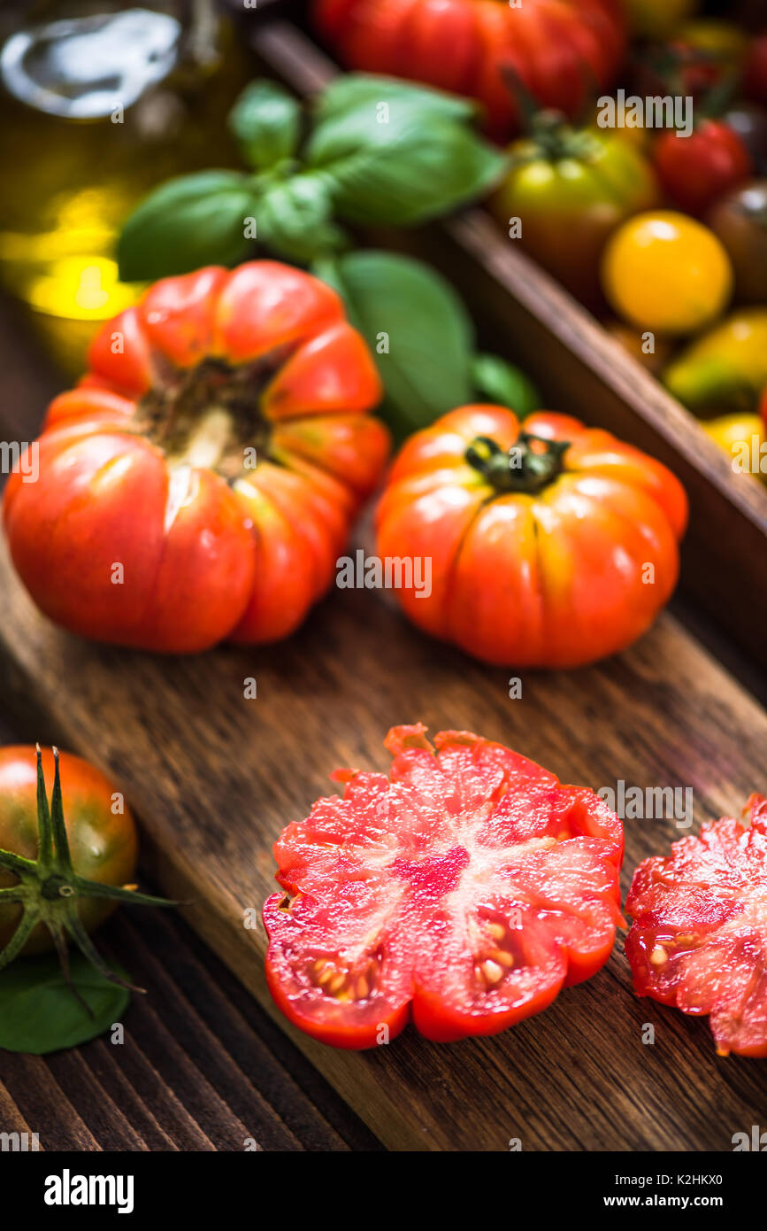 Red tomato cut in half on board Stock Photo - Alamy