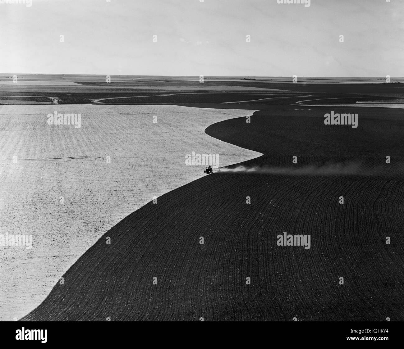 AERIAL VIEW OF TRACTOR TILLING FIELD Stock Photo