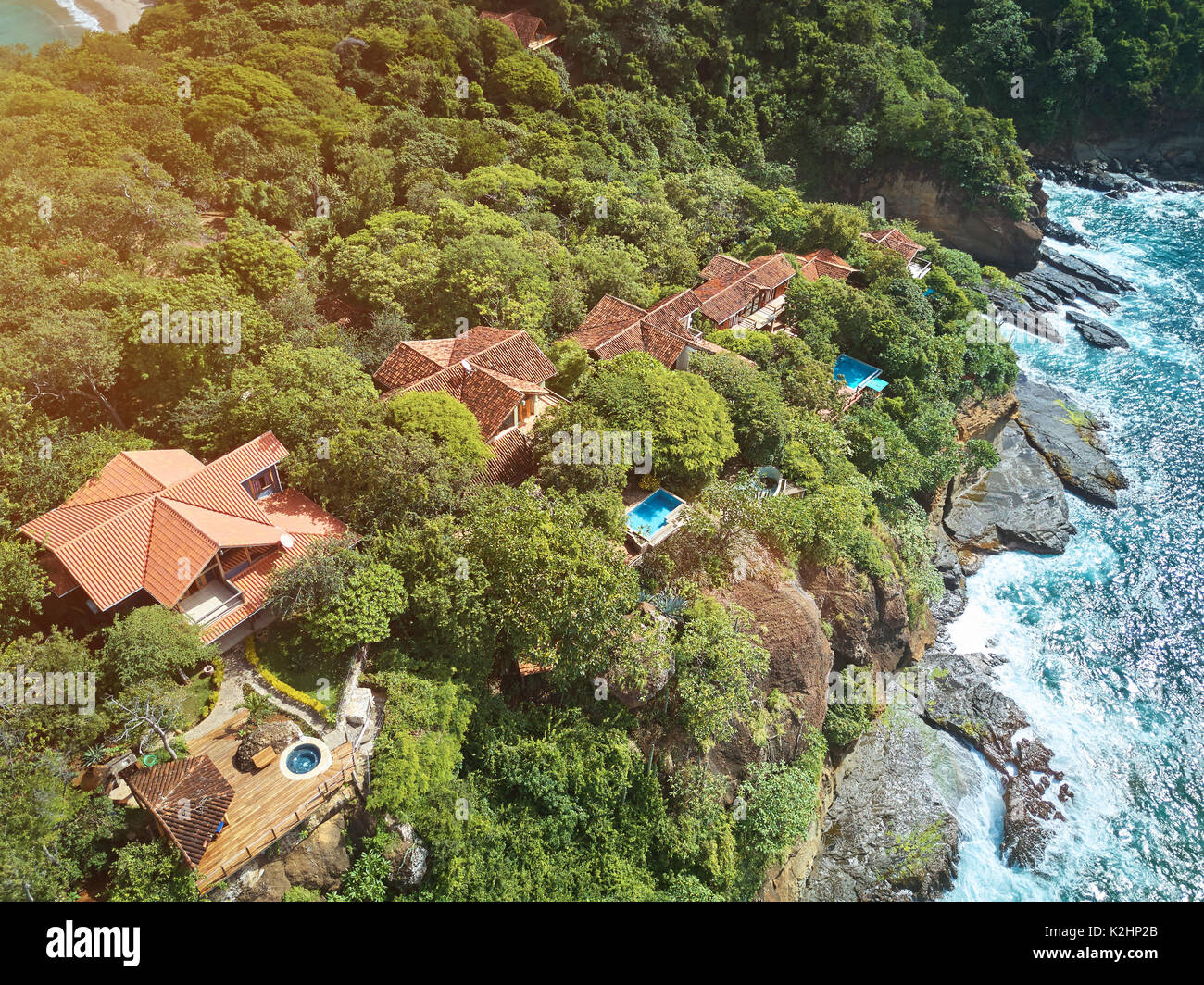 Villas and houses in cliff next to ocean aerial drone view Stock Photo