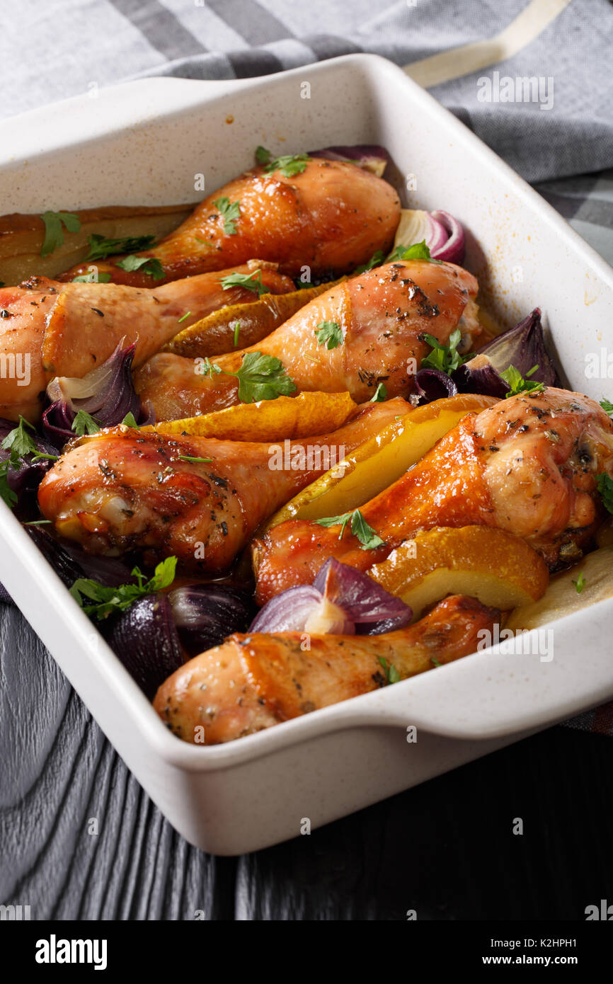 Chicken legs baked with red onions and greens in honeysoy sauce close