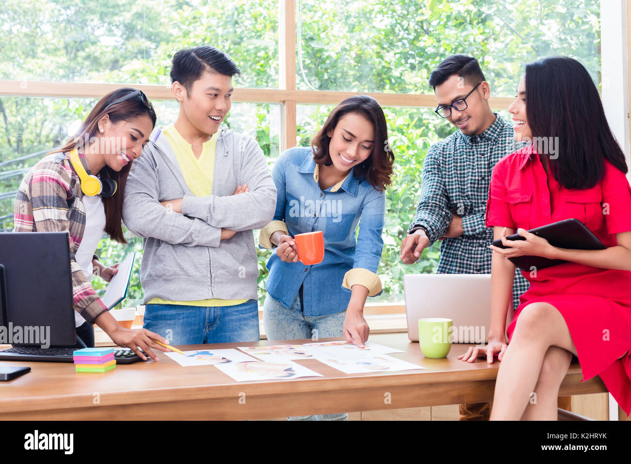 Young team analyzing business information during brainstorming m Stock Photo