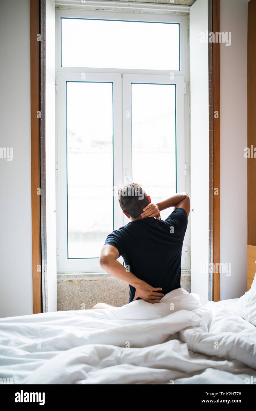 Man feeling back ache in the bed after sleeping Stock Photo Alamy