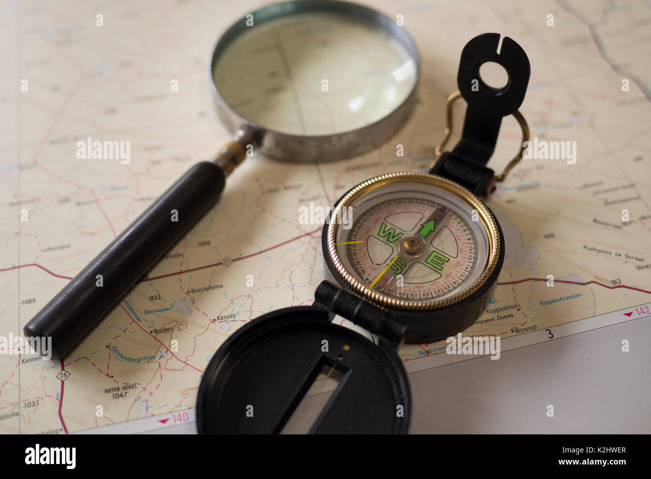 Compass and magnifying glass on a map Stock Photo Alamy