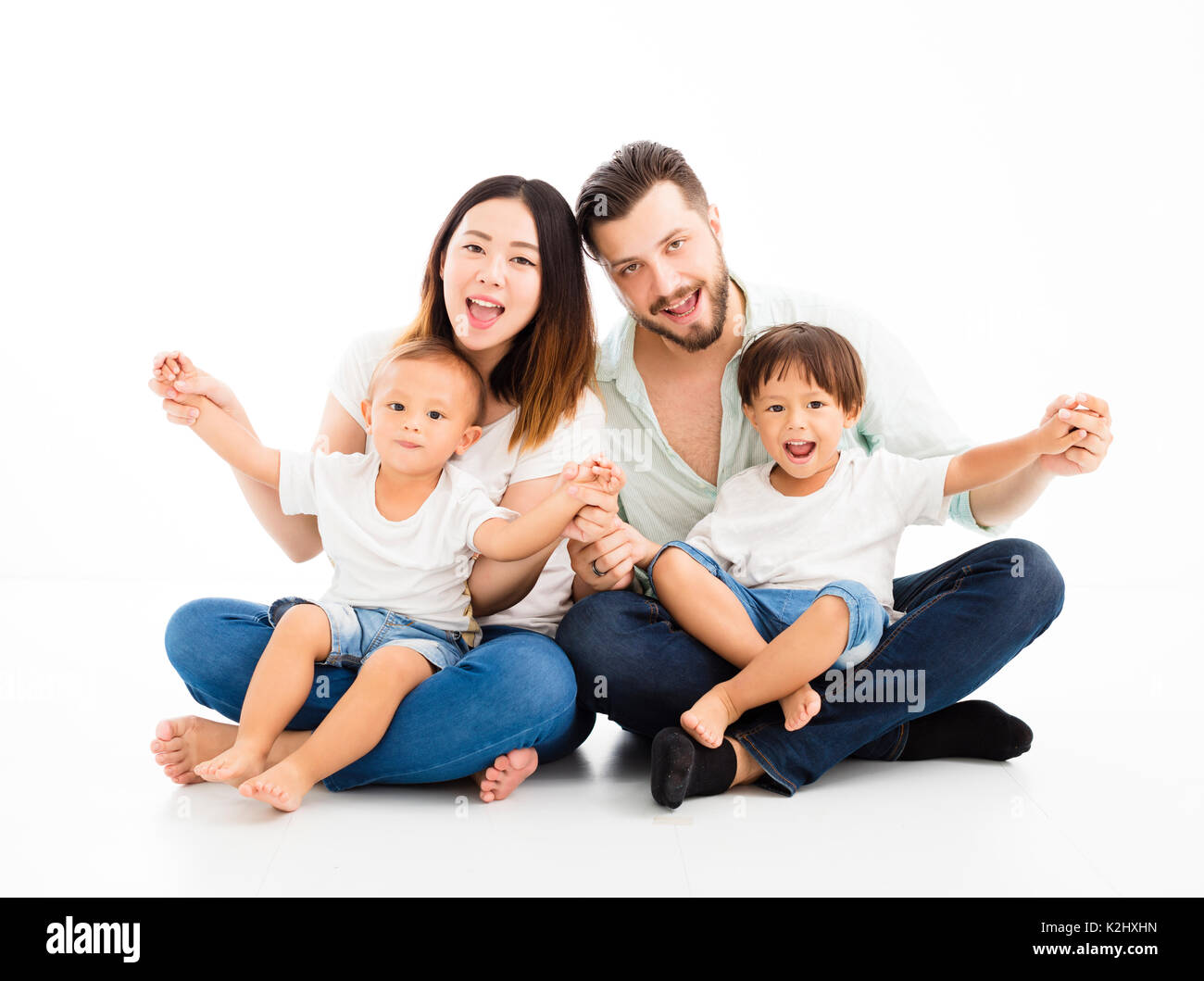 happy mixed race family sitting together Stock Photo