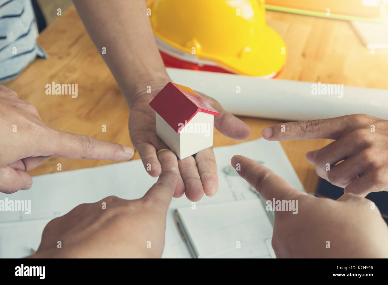 Engineer and Architect concept, Engineer Architects office team working and discussing with blueprints and house model, Stock Photo