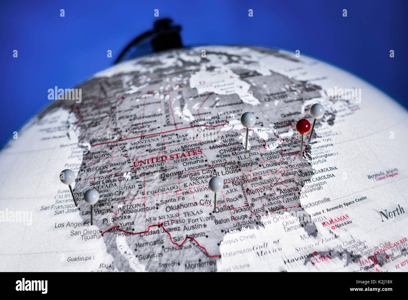 Detail of a globe with the USA in focus. Capital and five largest cities are marked with pinned needles. Stock Photo
