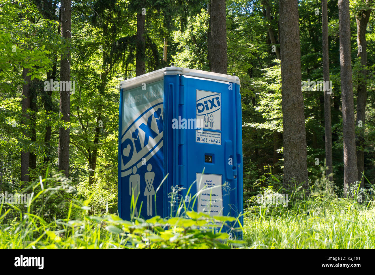 A mobile toilet cabin from TOI TOI & DIXI sanitary systems in a woodland part in the Taunus near Frankfurt, Germany. Stock Photo