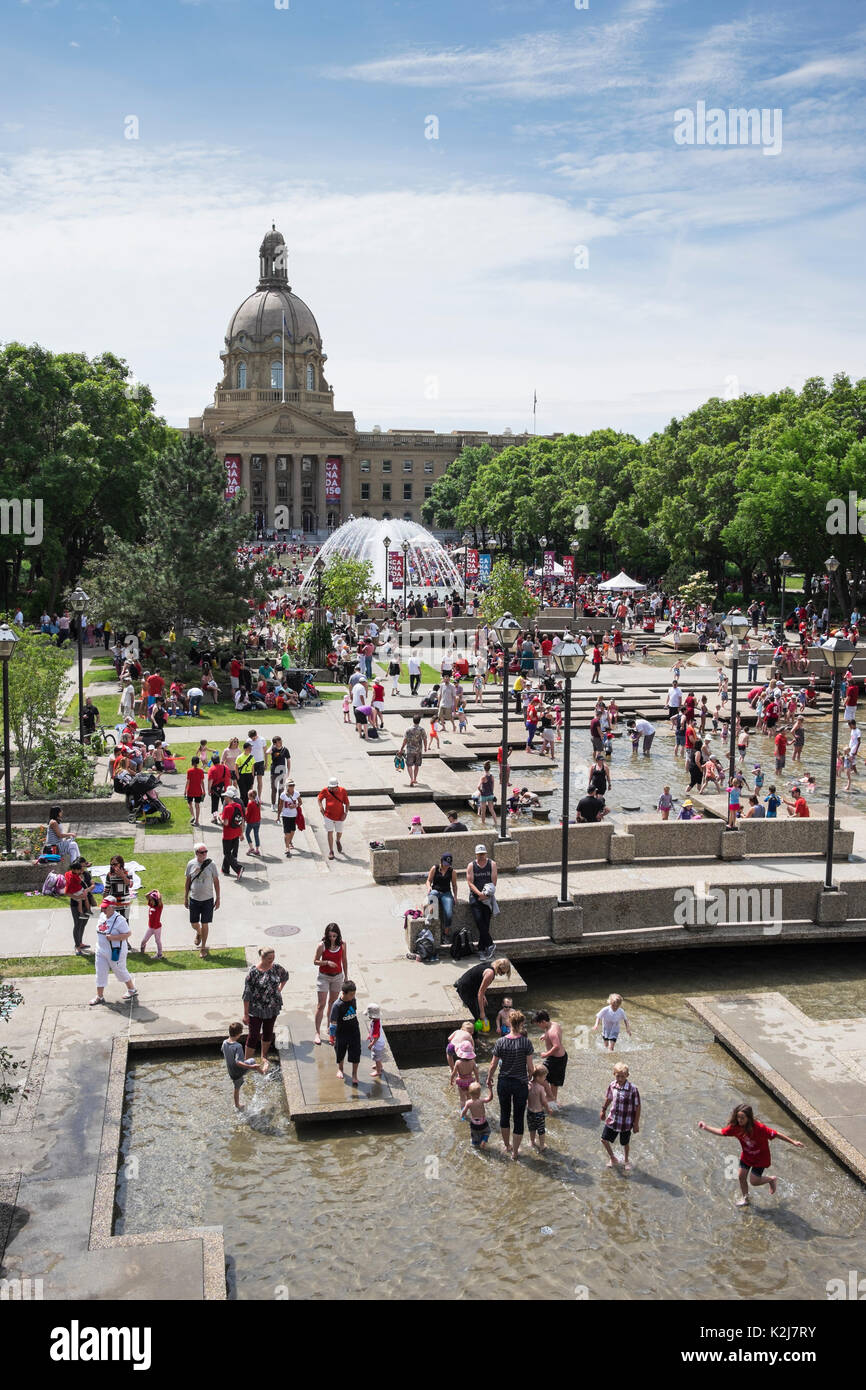 Adults and children playing in water fountains at Alberta Legislature Building, Alberta, Canada Stock Photo