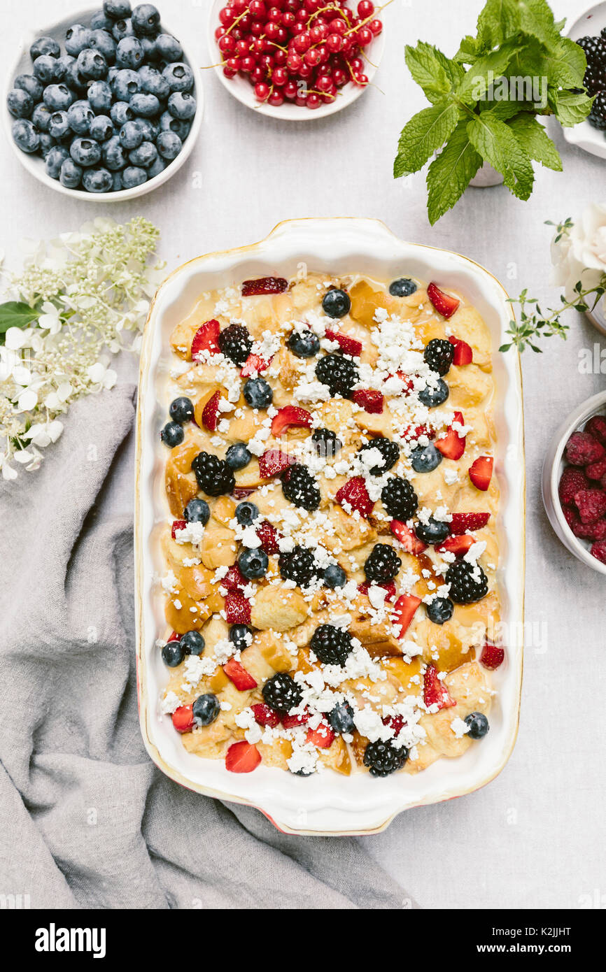 A goat cheese & berry bread pudding is photographed from above before