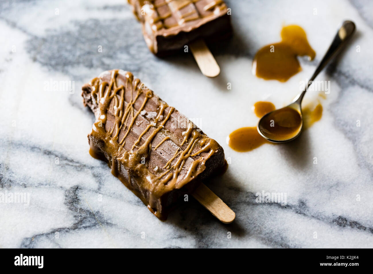 Healthy vegan salted caramel & chocolate swirl popsicles Stock Photo