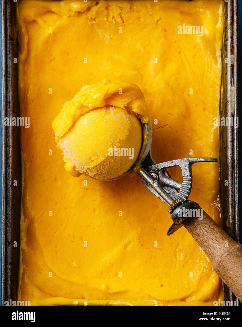 https://c8.alamy.com/comp/K2JK2A/sorbet-mango-ice-cream-ball-in-scoop-close-up-K2JK2A.jpg