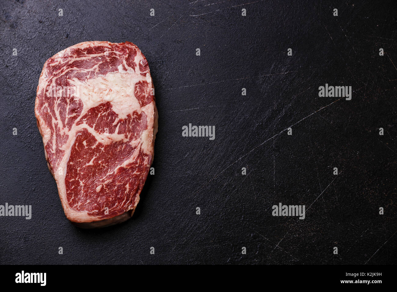 Raw fresh marbled meat Steak Rib eye Black Angus on dark background copy space Stock Photo