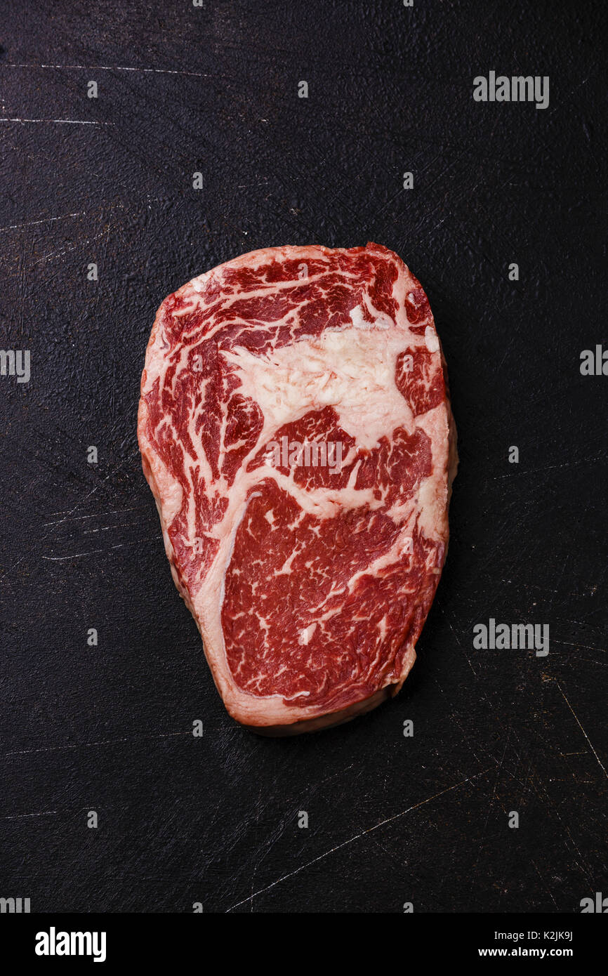 Raw fresh marbled meat Steak Rib eye Black Angus on dark background Stock Photo