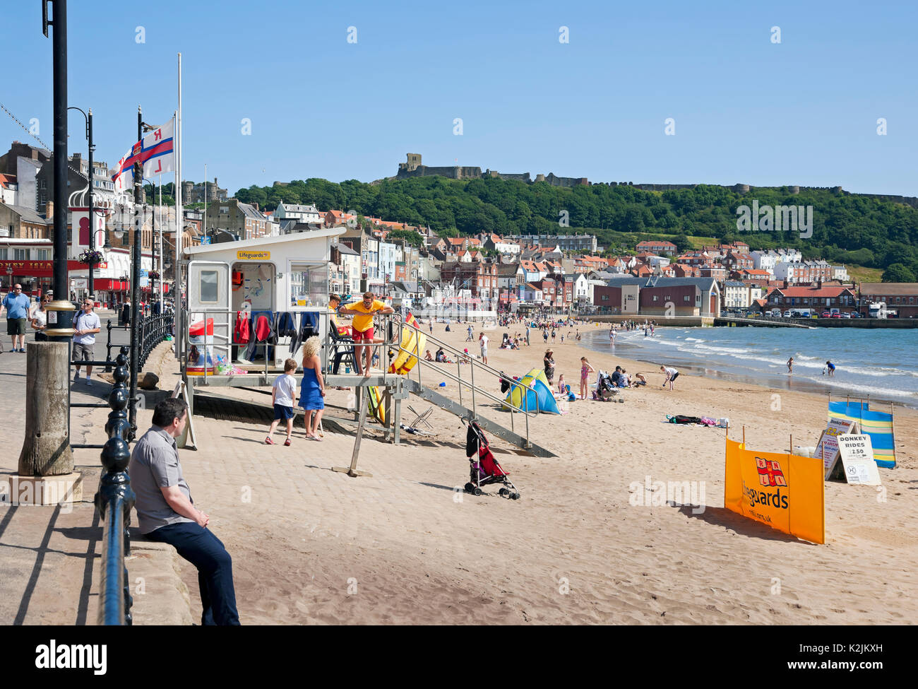 RNLI lifeguard station hut and people visitors tourists in summer South Bay Scarborough Beach North Yorkshire England UK United Kingdom Britain Stock Photo